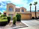Two-story home boasting a two-car garage, desert landscaping, and a classic Southwest design at 1628 Palmae Way, Las Vegas, NV 89128
