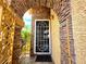 Charming front porch features a white security door and stone-accented walls at 1628 Palmae Way, Las Vegas, NV 89128