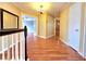 Upstairs hallway featuring hardwood floors, white banisters, and natural light, offering a grand entrance at 1628 Palmae Way, Las Vegas, NV 89128