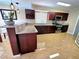 Open-concept kitchen boasts granite countertops, modern appliances, and a convenient breakfast bar at 1628 Palmae Way, Las Vegas, NV 89128