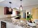 Updated kitchen featuring granite countertops, stainless steel appliances, and stylish pendant lighting at 1628 Palmae Way, Las Vegas, NV 89128