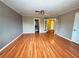 Spacious living room with hardwood floors and double French doors, perfect for entertaining at 1628 Palmae Way, Las Vegas, NV 89128