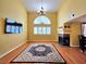 Bright living room featuring a fireplace, wood floors, and large arch window at 1628 Palmae Way, Las Vegas, NV 89128