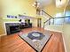 Bright living room featuring a fireplace, wood floors, and staircase to the second floor at 1628 Palmae Way, Las Vegas, NV 89128