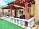 Backyard with a covered patio, ample seating, and a white balustrade at 1628 Palmae Way, Las Vegas, NV 89128