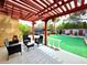 Outdoor patio area with a pergola, and black wicker furniture at 1628 Palmae Way, Las Vegas, NV 89128