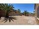 Low maintenance backyard with rock landscaping, a patio, privacy wall, and palm trees at 1777 Gentle Brook St, North Las Vegas, NV 89084