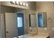Bathroom with vanity and mirror, door to separate toilet and shower space at 1777 Gentle Brook St, North Las Vegas, NV 89084