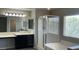 Bathroom featuring double sinks, large mirror, and a separate shower and tub at 1777 Gentle Brook St, North Las Vegas, NV 89084