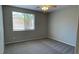 Bedroom featuring neutral walls, plush carpeting, and a window overlooking the backyard at 1777 Gentle Brook St, North Las Vegas, NV 89084