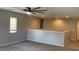 Upstairs bonus room with plush carpet, plenty of natural light, and a ceiling fan at 1777 Gentle Brook St, North Las Vegas, NV 89084