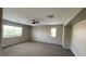 Carpeted bonus room featuring natural light, neutral walls and a ceiling fan at 1777 Gentle Brook St, North Las Vegas, NV 89084