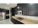 Spacious kitchen featuring stainless steel appliances, granite counters, and dark wood cabinets at 1777 Gentle Brook St, North Las Vegas, NV 89084