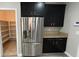 Spacious kitchen featuring stainless steel appliances, dark wood cabinets, and a pantry at 1777 Gentle Brook St, North Las Vegas, NV 89084