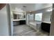 Main bathroom featuring dual sinks, a soaking tub, a separate shower, and wood-look flooring at 1777 Gentle Brook St, North Las Vegas, NV 89084