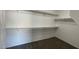 Spacious walk-in closet featuring ample shelving for optimal storage in a neutral color palette at 1777 Gentle Brook St, North Las Vegas, NV 89084