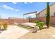 Backyard featuring a sitting area, desert landscaping, retaining wall, and lion statues at 2 Lago Turchino Ct, Henderson, NV 89011