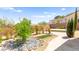 Lush backyard with desert landscaping, gravel, and mature plants at 2 Lago Turchino Ct, Henderson, NV 89011