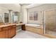 Gorgeous bathroom with granite countertops, soaking tub, glass enclosed shower, and dual sinks at 2 Lago Turchino Ct, Henderson, NV 89011