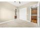 Carpeted bedroom showcasing closet, ensuite bathroom and storage cabinets at 2 Lago Turchino Ct, Henderson, NV 89011