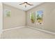 Bright bedroom featuring neutral walls, carpet flooring, a ceiling fan, and large windows at 2 Lago Turchino Ct, Henderson, NV 89011