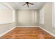 Cozy bedroom offers hardwood flooring, neutral walls, and a ceiling fan at 2 Lago Turchino Ct, Henderson, NV 89011