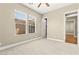 Bright, carpeted bedroom with a ceiling fan and windows; entrance to bathroom can be seen at 2 Lago Turchino Ct, Henderson, NV 89011