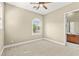 Bright bedroom with a ceiling fan, a window, and a view into the attached bathroom at 2 Lago Turchino Ct, Henderson, NV 89011