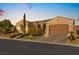 Charming single-story home with a well-manicured lawn, paver driveway, and attached two-car garage at 2 Lago Turchino Ct, Henderson, NV 89011
