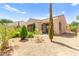 Exterior elevation with desert landscaping, mature trees, and covered porch at 2 Lago Turchino Ct, Henderson, NV 89011