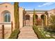 Inviting front entry with a stone pathway, desert landscaping, and covered porch at 2 Lago Turchino Ct, Henderson, NV 89011