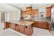 Gourmet kitchen with large island, tile backsplash, and access to open floor plan at 2 Lago Turchino Ct, Henderson, NV 89011