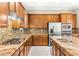 Well-equipped kitchen featuring granite countertops, stainless steel appliances, and tile backsplash at 2 Lago Turchino Ct, Henderson, NV 89011