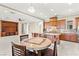 Open-concept kitchen with center island, dining area, and built-in shelving at 2 Lago Turchino Ct, Henderson, NV 89011