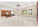Open-concept living area with tile floors, plantation shutters, and kitchen access at 2 Lago Turchino Ct, Henderson, NV 89011