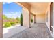 Covered patio features brick and paver flooring with desert landscaping at 2 Lago Turchino Ct, Henderson, NV 89011