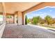 Large covered patio with brick flooring, pillars, and landscaped garden at 2 Lago Turchino Ct, Henderson, NV 89011