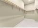 Walk-in closet with tile flooring, and shelf and rod system ready to organize at 2 Lago Turchino Ct, Henderson, NV 89011