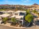 Aerial view of a modern home in a desert community with mountain views at 21 Highland Cove Ln, Henderson, NV 89011