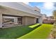 Modern backyard with lush, green artificial turf and seamless indoor/outdoor living at 21 Highland Cove Ln, Henderson, NV 89011