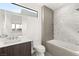 Modern bathroom with soaking tub, tiled accent wall, and sleek vanity with stylish fixtures at 21 Highland Cove Ln, Henderson, NV 89011
