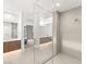 Luxurious bathroom with a glass shower, dual vanities, modern fixtures, and natural light at 21 Highland Cove Ln, Henderson, NV 89011
