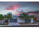 Contemporary home with a modern design, clean lines, and a well-manicured front yard at dusk at 21 Highland Cove Ln, Henderson, NV 89011