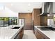 Sleek kitchen with custom cabinetry, marble countertops, stainless steel appliances, and a large island at 21 Highland Cove Ln, Henderson, NV 89011