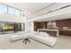 Open-concept living room with loft and kitchen offers contemporary design and seamless indoor-outdoor living at 21 Highland Cove Ln, Henderson, NV 89011
