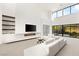 Spacious living room with modern fireplace, large windows, and stylish decor for ultimate comfort at 21 Highland Cove Ln, Henderson, NV 89011