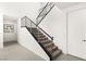 Contemporary staircase with metal railings and carpeted steps, connecting multiple levels of the home at 21 Highland Cove Ln, Henderson, NV 89011