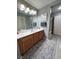 Spacious bathroom with a vanity, a large mirror, a shower/tub combo, and neutral decor at 23 E Agate Ave # 301, Las Vegas, NV 89123