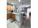 Well-lit kitchen featuring wood cabinets, stainless steel appliances, and an adjacent dining area at 23 E Agate Ave # 301, Las Vegas, NV 89123
