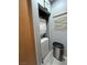 Efficient laundry room with stacked washer and dryer, complemented by a gray color scheme at 23 E Agate Ave # 301, Las Vegas, NV 89123